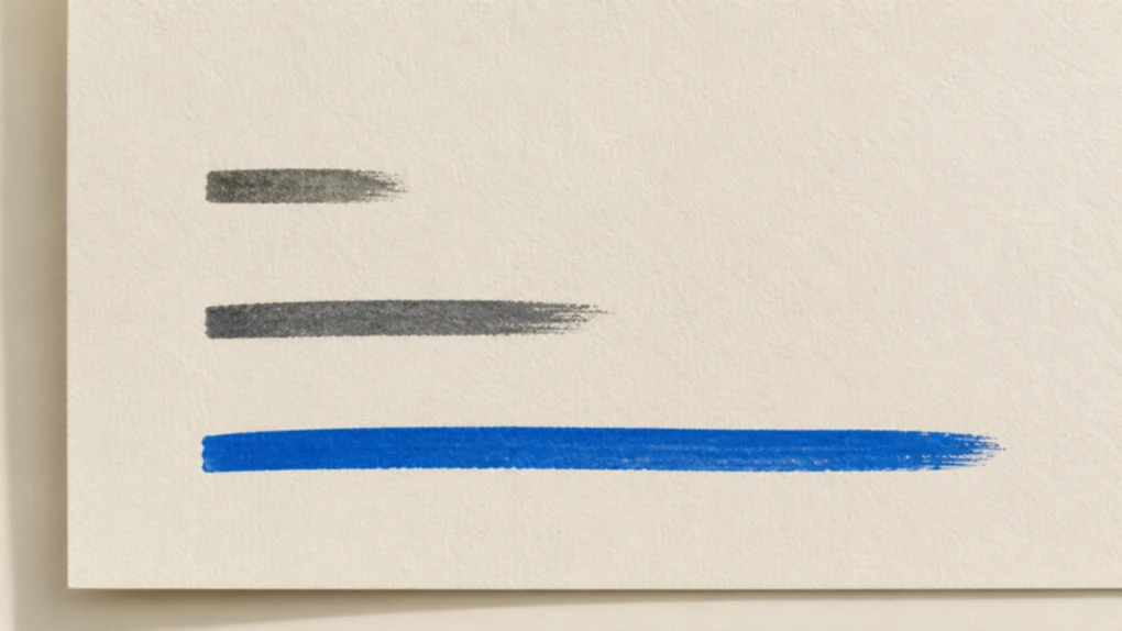 Three ink strokes painted on cream paper and stacked from shortest to longest, with the longest one, the em dash, in bright blue